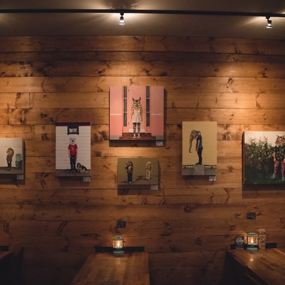 Wooden wall with wall art, picnic tables.