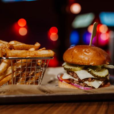 Double cheeseburger, served with fries, front view.