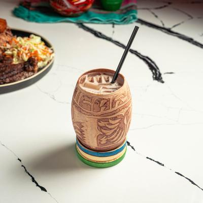 Cocktail in a carved wooden cup.
