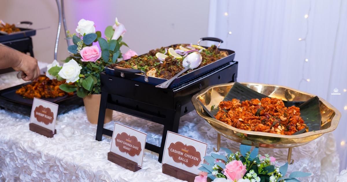 A catered buffet table featuring Indian cuisine dishes