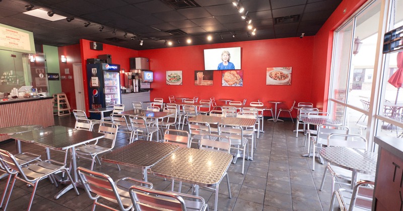 Interior, dining area, tables ready for guests, soda fountain, drinks fridge, TV on the wall