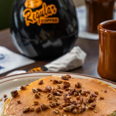 Close-up of buttermilk pancakes topped with walnuts.