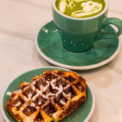 Matcha latte and a waffle dessert.