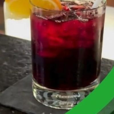 An iced drink garnished with an orange slice.