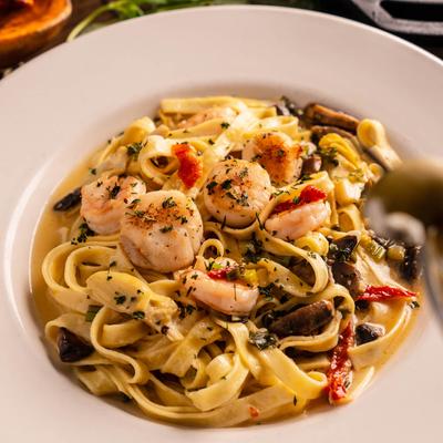 Fettuccini pasta, with shrimp, scallops, artichokes, tomatoes, mushrooms, and capers.