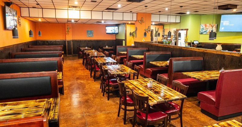 Interior, view of dining area, tv screens on the wall