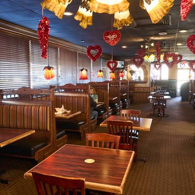 Interior featuring wooden booths, pendant lights, and heart-shaped decorations.