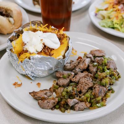 Filet Tips served with a loaded baked potato.
