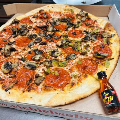 Pepperoni and mushroom pizza in a box.