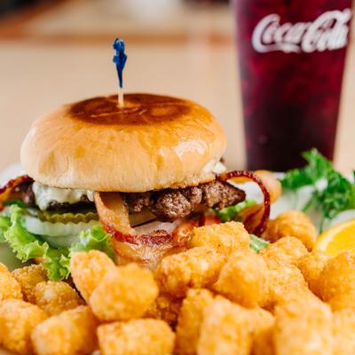 Bacon cheeseburger served with tater tots.