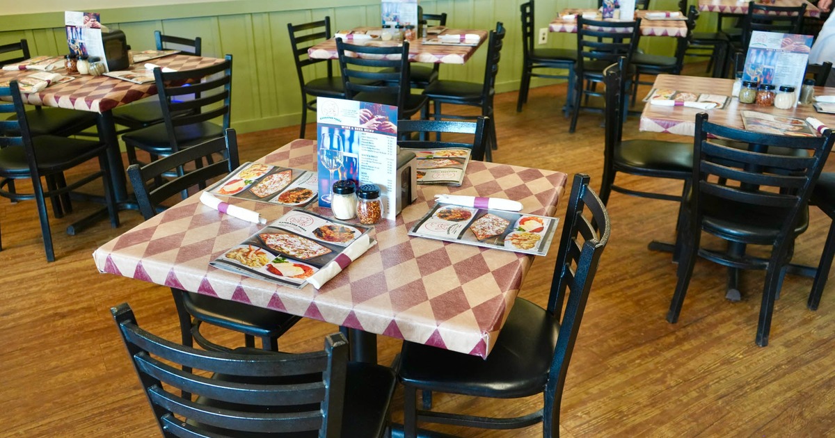 Interior seating area with tables for four people