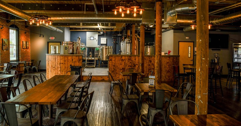 Interior, seating area with brewing equipment in the background