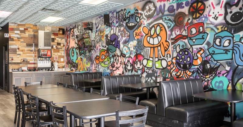 Interior seating area with a long table and upholstered booths
