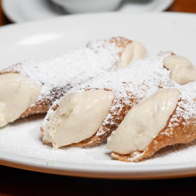 Cannolis, with powdered sugar.