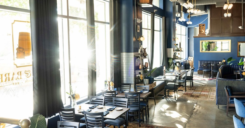 Interior, tables set for guests near windows