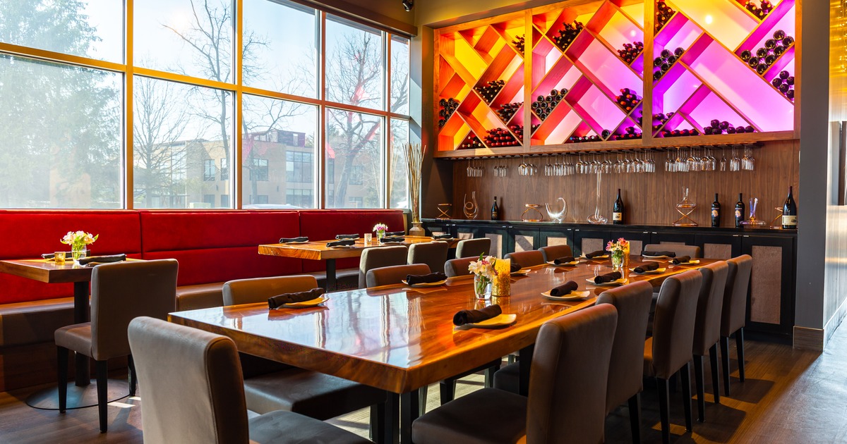 Main dining area with a wine rack in the background