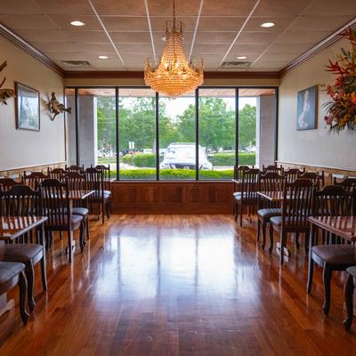 A large dining hall with tables and chairs.