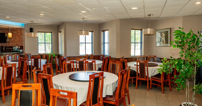 Interior, rounded tables ready for guests