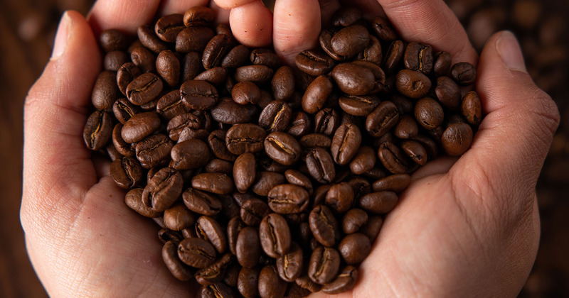 Hands holding coffee beans