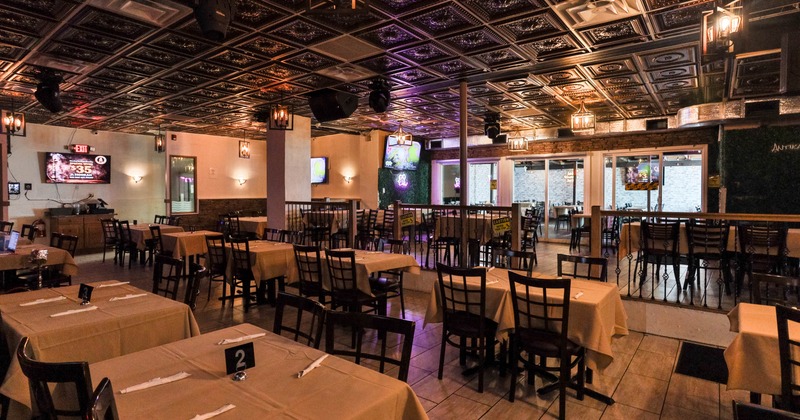 Interior, open space dining area, tables for four, elevated platform with seating capacities