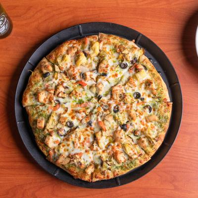 Whole Pesto Supreme Pizza, overhead view.