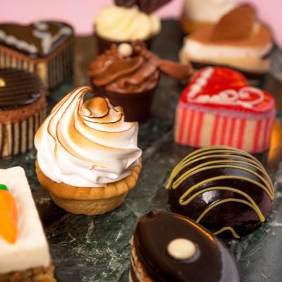 Variety of bite-sized desserts and mini cakes.