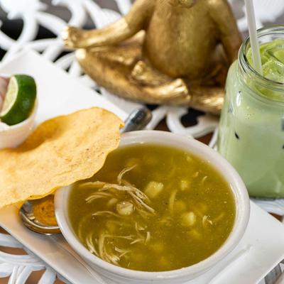 Chicken pozole soup with tortilla.