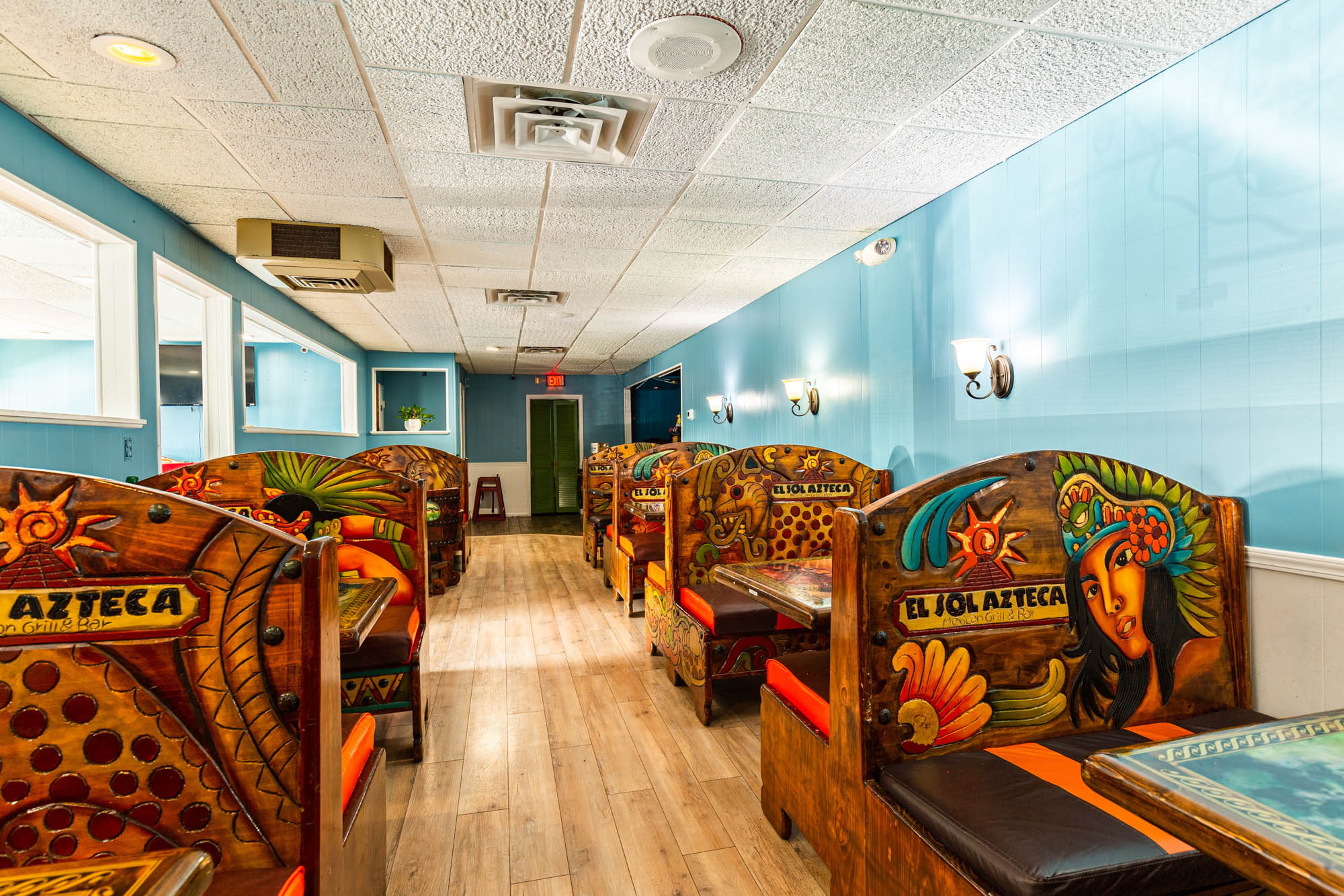 Painted restaurant booths and seats with sea world and desert motifs