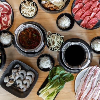Various pots, plates and cups with different ingredients.