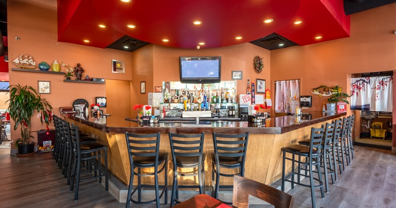 Diner table, bar with chairs and tv above