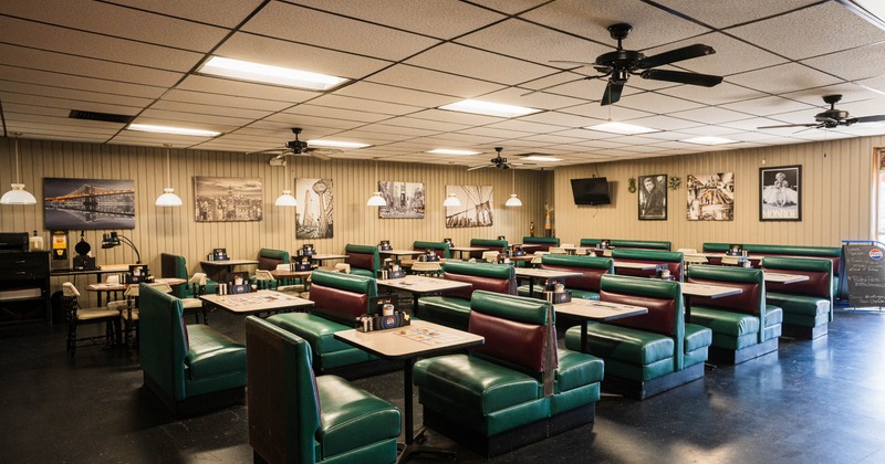 Interior, dining area, leather sheeted seating booths, wooden top tables for four