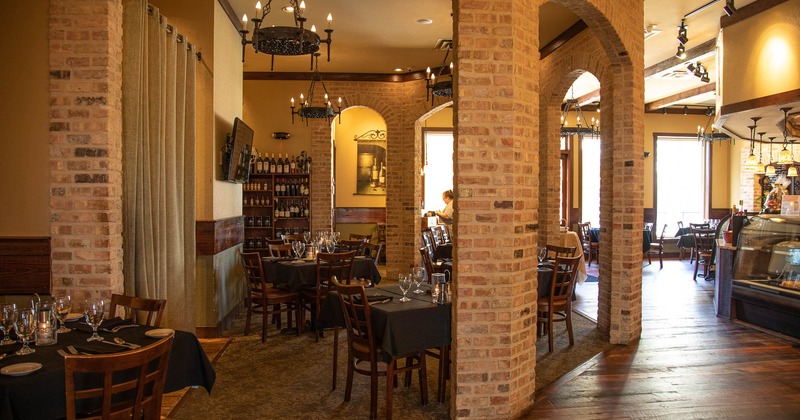Interior, seating area, lots of bottles on the shelf, TV screen, restaurant decoration