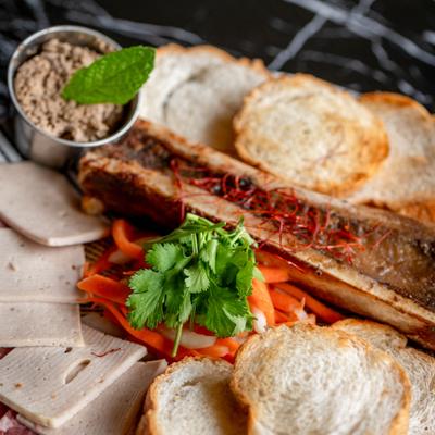Roasted bone marrow accompanied by toasted bread and a fresh salad.