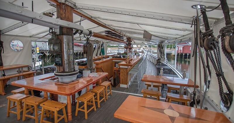 Covered outdoor dining and bar area on a docked boat