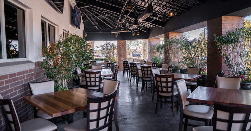 Exterior, roof covered patio with tables and chairs