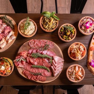 Assortment of meat boars and sides spread on a table, top view.