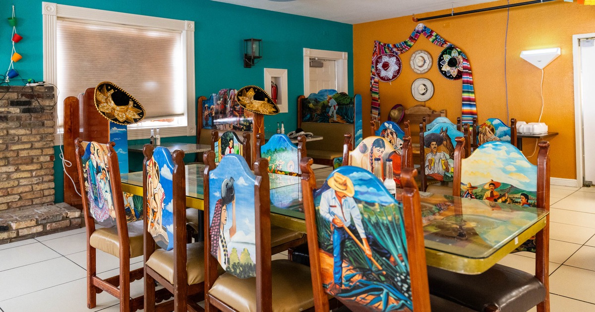 A vibrant dining area with hand painted Mexican themed chairs and colorful decor