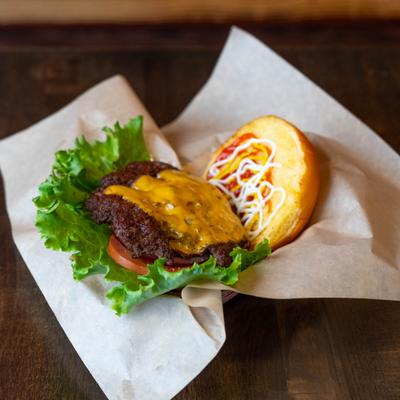 Cheeseburger with lettuce and tomato.