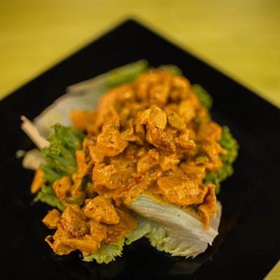 Curry Chicken Salad served with lettuce and fresh herbs.