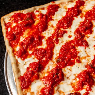 Pizza pastry with tomato sauce on top