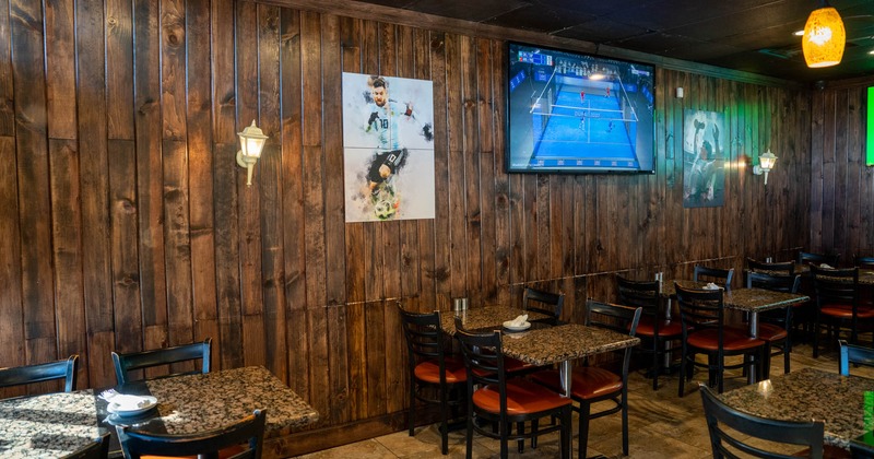 Interior, tables, chairs, wall TV, wall paintings, lights