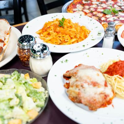 Various dishes served on the table with condiments.