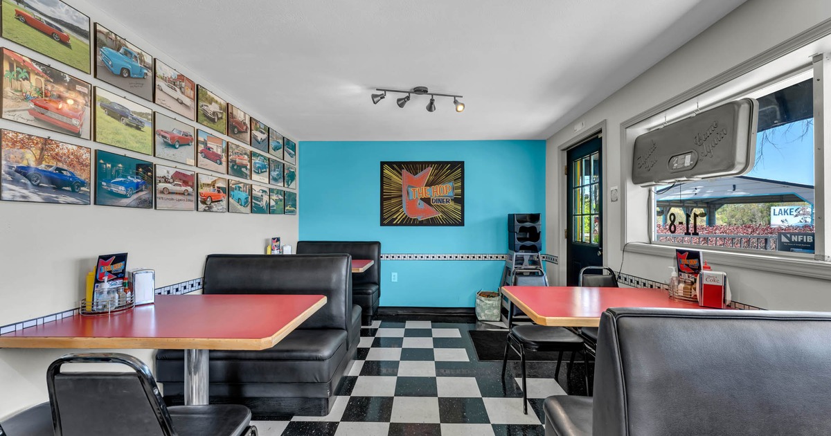 Interior seating area with booths, chairs and tables