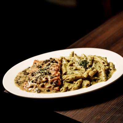 Salmon Piccata topped with a creamy caper lemon sauce and served with Penne Pesto.