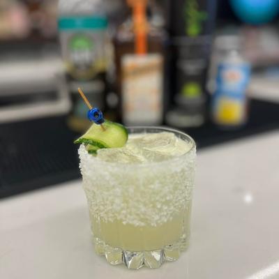 Margarita cocktail in a rocks glass, garnished with cucamber.