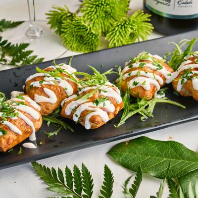 Beef and mushroom Wellington topped with horseradish cream sauce and parsley.