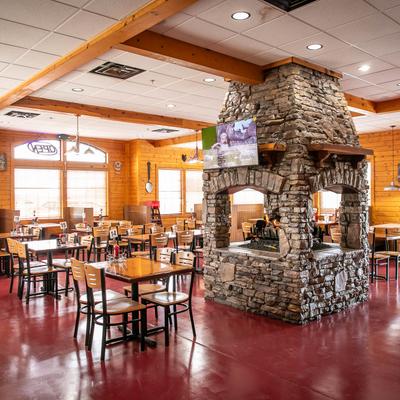 Interior, dining area, seating around the fireplace.