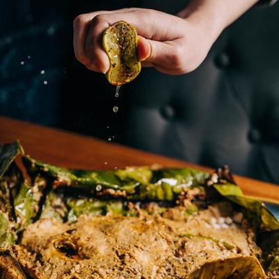 Squeezed lemon over Macher Paturi dish.