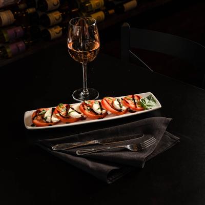 Caprese salad with tomato, mozzarella, basil, and balsamic.