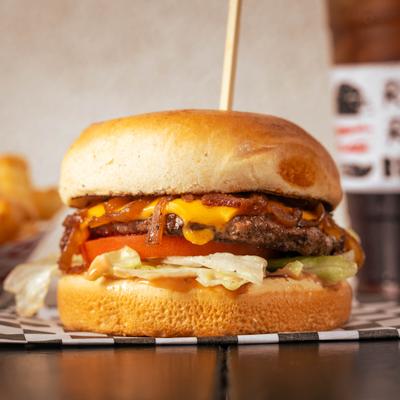 Cheeseburger with house sauce, lettuce, tomato, and grilled onions.